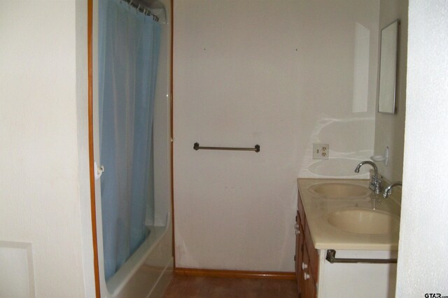 411 N College St, Lindale, TX 75771 - bathroom with double vanity, baseboards, and shower / bath combination with curtain