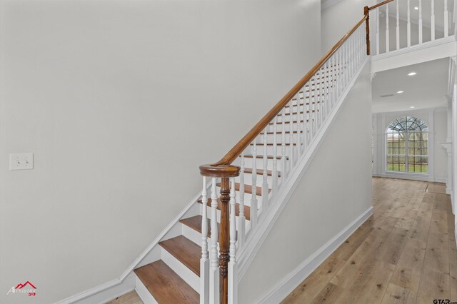 6309 Gleneagles, Tyler, TX 75703 - stairs with baseboards, recessed lighting, a high ceiling, and hardwood / wood-style flooring