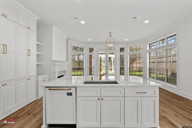 6309 Gleneagles, Tyler, TX 75703 - kitchen featuring white cabinetry, open shelves, ornamental molding, visible vents, and white dishwasher