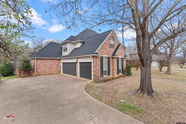 6309 Gleneagles, Tyler, TX 75703 - view of home's exterior with roof with shingles, concrete driveway, fence, an attached garage, and brick siding