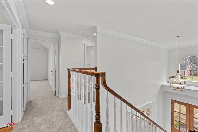 6309 Gleneagles, Tyler, TX 75703 - hallway with light colored carpet, crown molding, an upstairs landing, and a chandelier