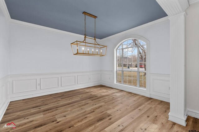 6309 Gleneagles, Tyler, TX 75703 - unfurnished dining area with decorative columns, crown molding, light wood-style floors, and a chandelier