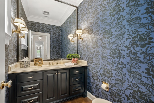 1920 Stonegate Blvd, Tyler, TX 75703 - bathroom with visible vents, crown molding, wallpapered walls, wood finished floors, and vanity