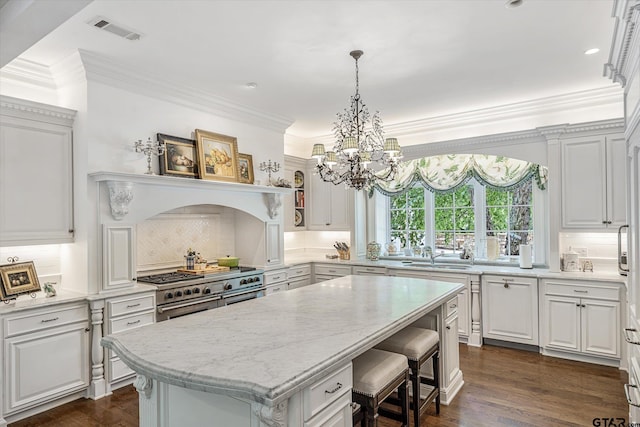 1920 Stonegate Blvd, Tyler, TX 75703 - kitchen with white cabinets, visible vents, a chandelier, and a kitchen island