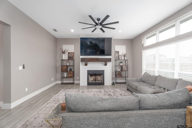 15365 Spring Oaks Dr, Lindale, TX 75771 - living room featuring a ceiling fan, light wood-style floors, a fireplace, and recessed lighting