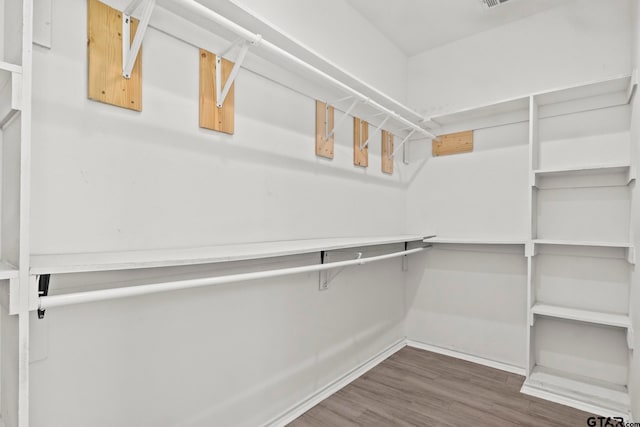 walk in closet featuring dark wood-type flooring