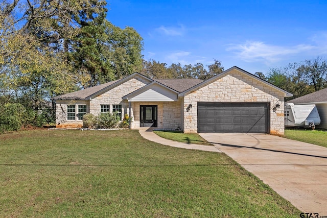 ranch-style home featuring a garage and a front lawn