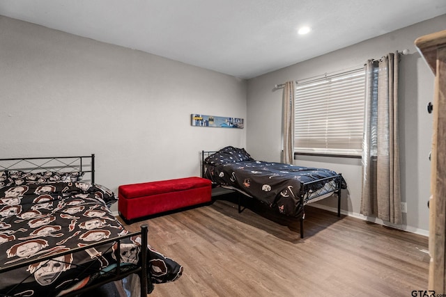 bedroom with wood-type flooring