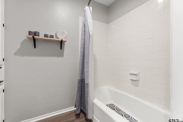 bathroom featuring shower / bathtub combination with curtain and hardwood / wood-style flooring