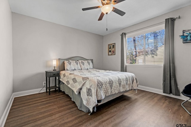 bedroom with dark hardwood / wood-style flooring and ceiling fan