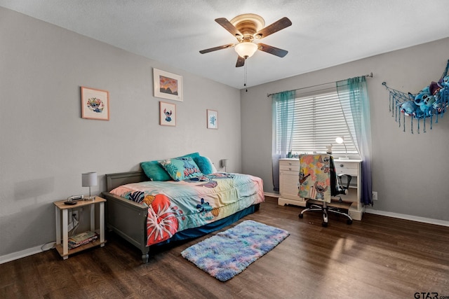 bedroom featuring a textured ceiling, ceiling fan, and dark hardwood / wood-style floors