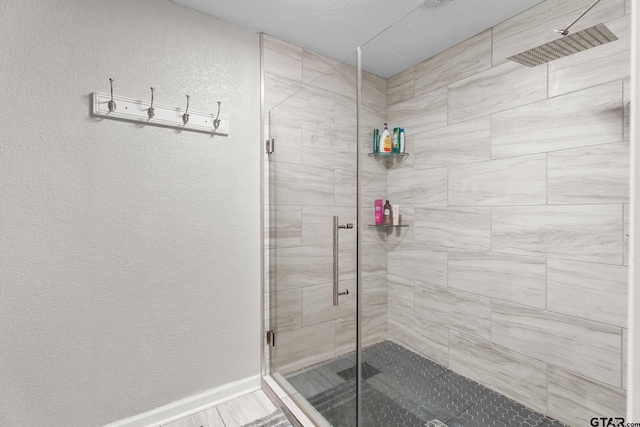 bathroom featuring a shower with door