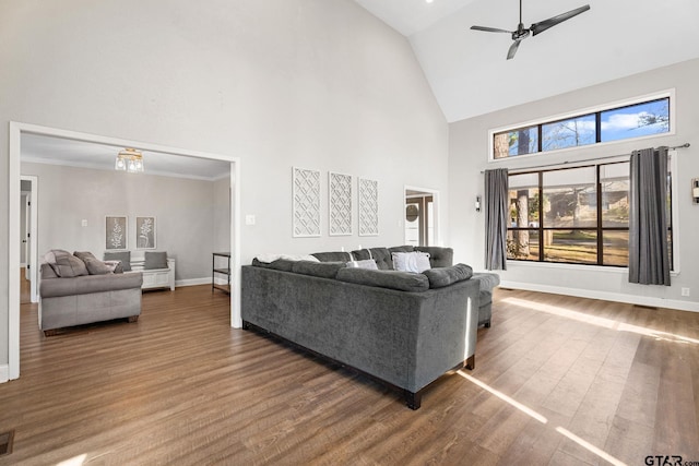 living room featuring ceiling fan, dark wood-type flooring, and high vaulted ceiling