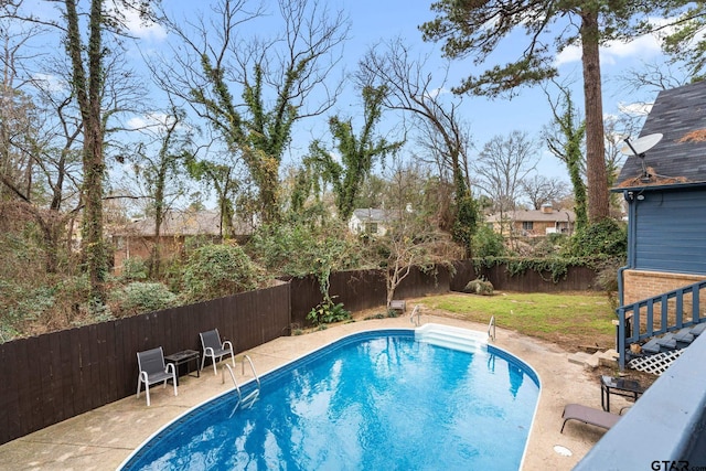 view of swimming pool featuring a yard and a patio