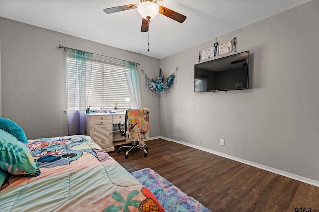 bedroom with dark hardwood / wood-style flooring and ceiling fan