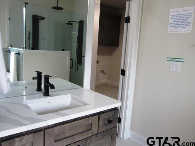 bathroom featuring vanity and a shower with door