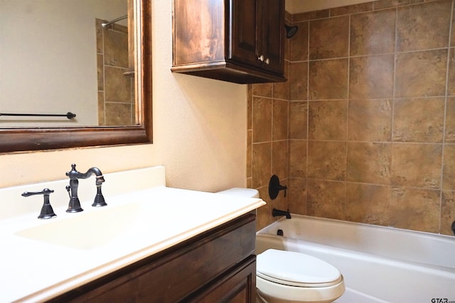 full bathroom with tiled shower / bath, toilet, and vanity