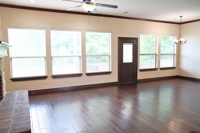 unfurnished living room with a fireplace, ceiling fan with notable chandelier, dark hardwood / wood-style floors, and crown molding