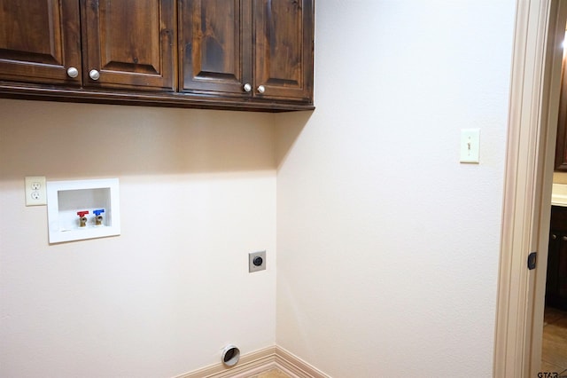 washroom featuring hookup for a washing machine, cabinets, and hookup for an electric dryer