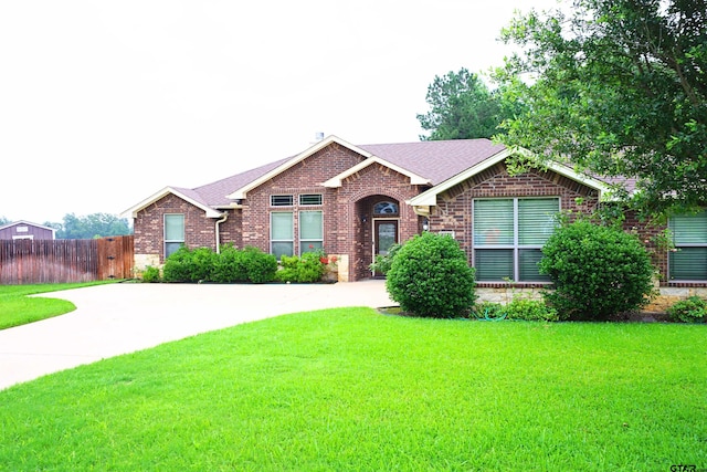 ranch-style home with a front lawn