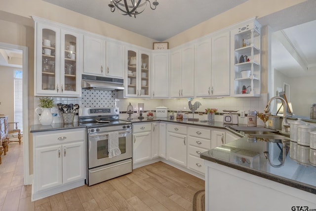 kitchen with white cabinets, decorative backsplash, stainless steel range oven, and sink