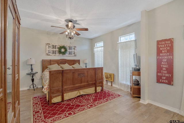 bedroom with ceiling fan, a closet, and hardwood / wood-style flooring