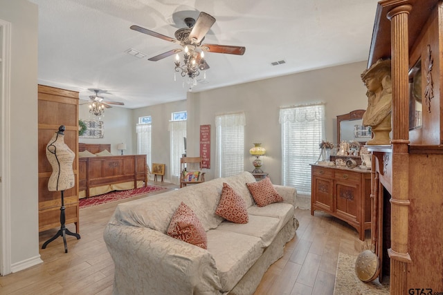 interior space with ceiling fan, light hardwood / wood-style flooring, and multiple windows