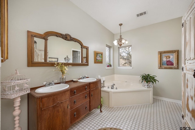 bathroom with vanity, a bathtub, and an inviting chandelier