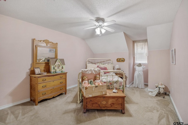 carpeted bedroom featuring vaulted ceiling, ceiling fan, and a textured ceiling