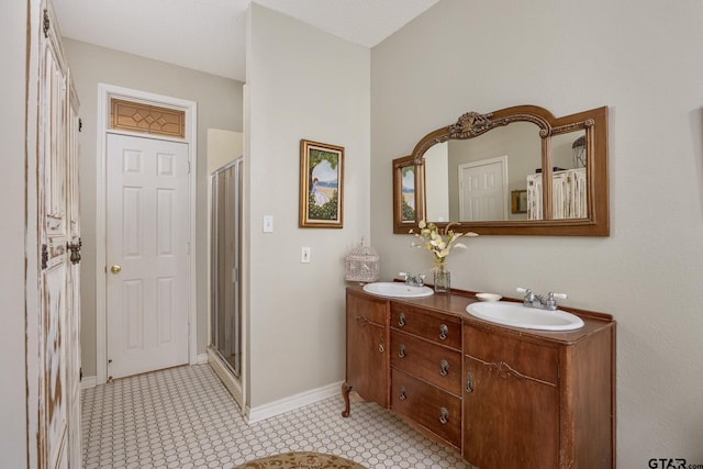 bathroom with a textured ceiling, tile patterned flooring, walk in shower, and vanity