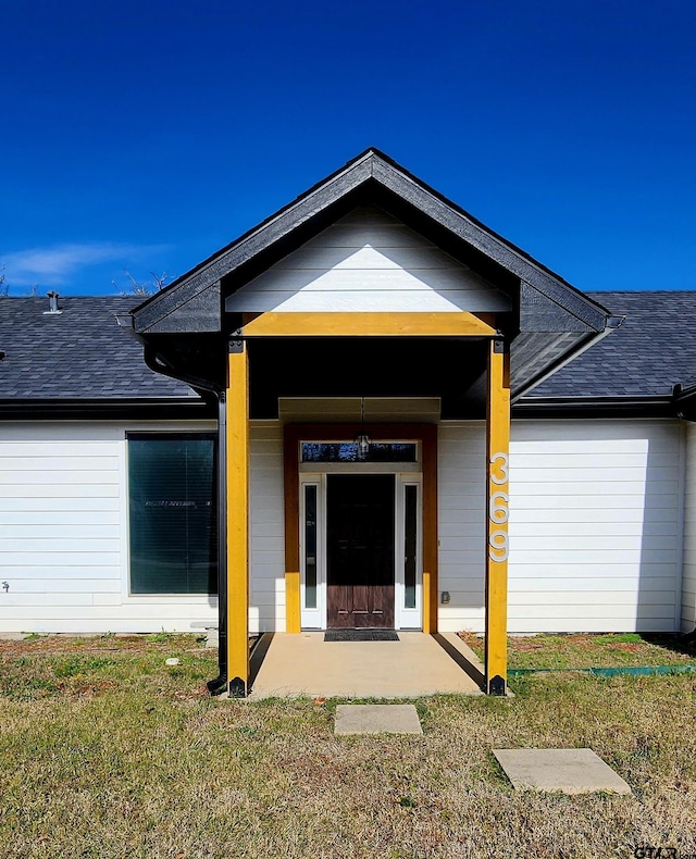 property entrance with a yard