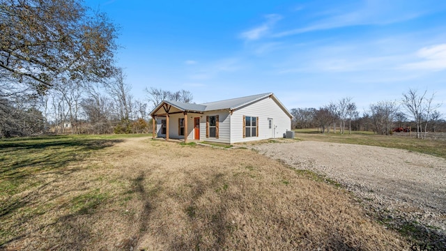 single story home with central AC, covered porch, and a front lawn