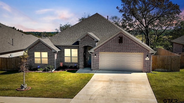 view of front facade featuring a lawn and a garage