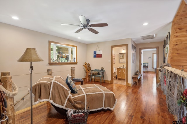 sitting room featuring wood-type flooring and ceiling fan