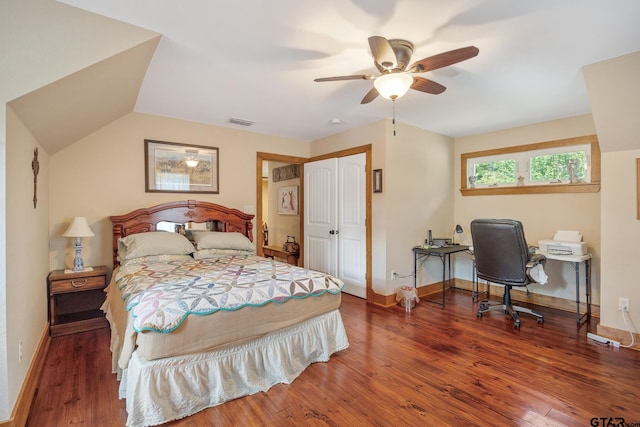 bedroom featuring dark wood-type flooring, a closet, vaulted ceiling, and ceiling fan