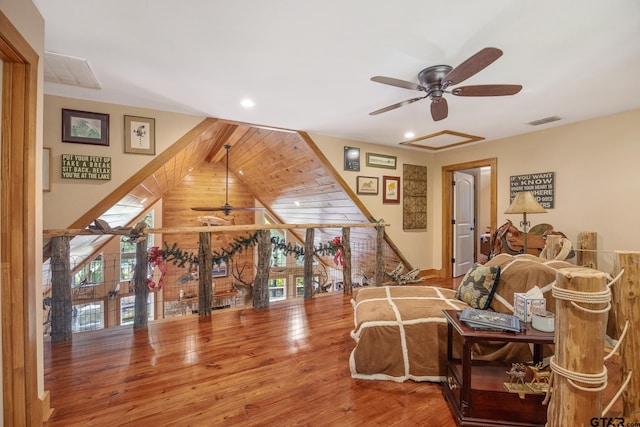 bedroom with hardwood / wood-style floors and multiple windows