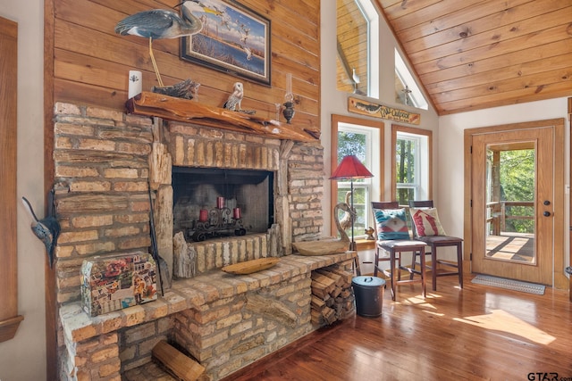 living room with hardwood / wood-style floors, wooden ceiling, vaulted ceiling, and a brick fireplace