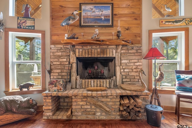 living area with hardwood / wood-style flooring, a fireplace, and a healthy amount of sunlight