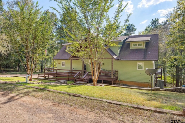 view of front of home featuring a front yard and a wooden deck