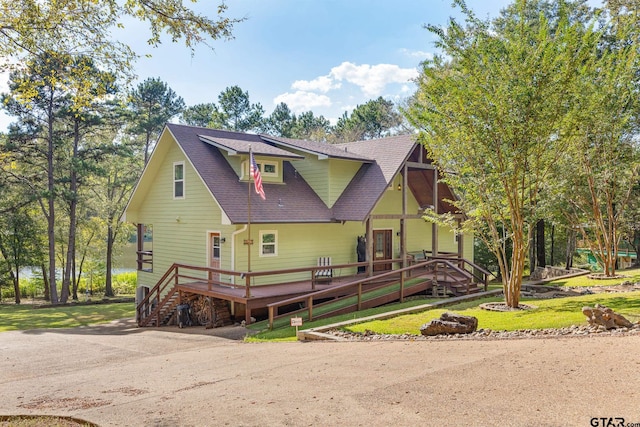 view of front of house with a front lawn and a deck