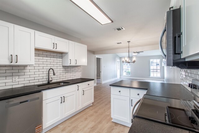 415 Thigpen Dr, Tyler, TX 75703 - kitchen featuring stainless steel appliances, a sink, dark countertops, light wood-type flooring, and tasteful backsplash