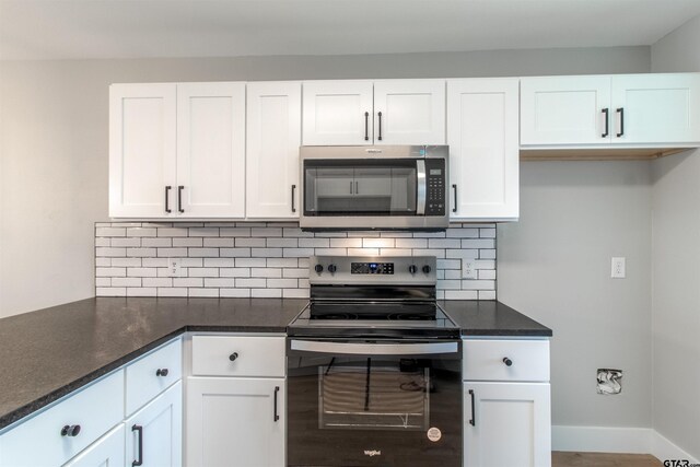 415 Thigpen Dr, Tyler, TX 75703 - kitchen featuring stainless steel appliances, white cabinets, decorative backsplash, and dark stone countertops