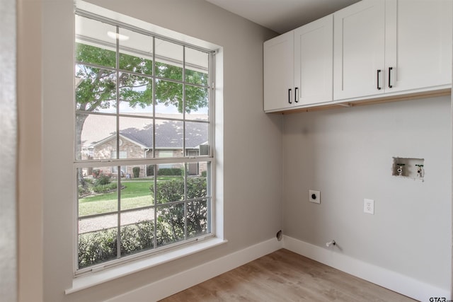 415 Thigpen Dr, Tyler, TX 75703 - washroom with electric dryer hookup, cabinet space, baseboards, hookup for a washing machine, and light wood-style flooring