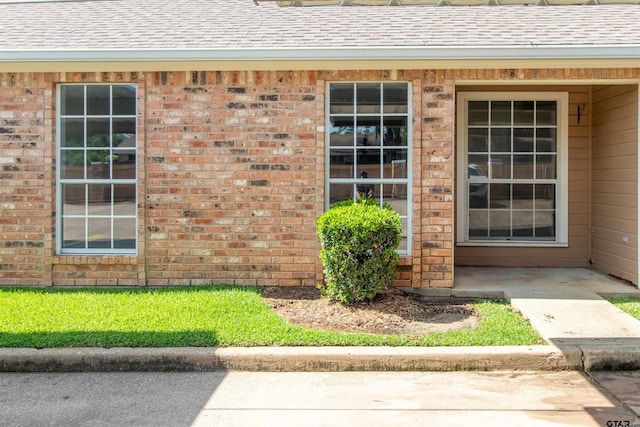 415 Thigpen Dr, Tyler, TX 75703 - property entrance featuring a shingled roof and brick siding