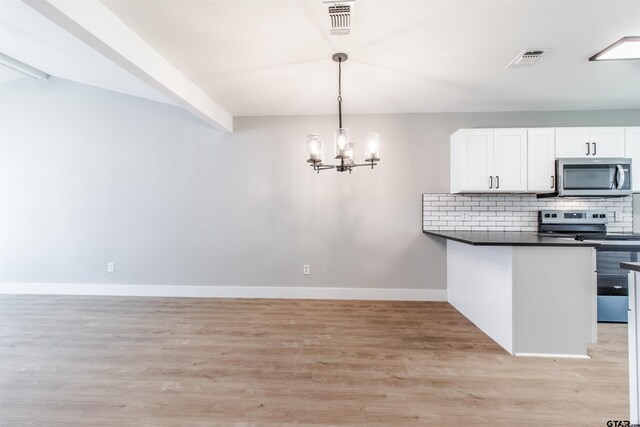 415 Thigpen Dr, Tyler, TX 75703 - kitchen featuring stainless steel appliances, light wood-style floors, a chandelier, dark countertops, and white cabinets