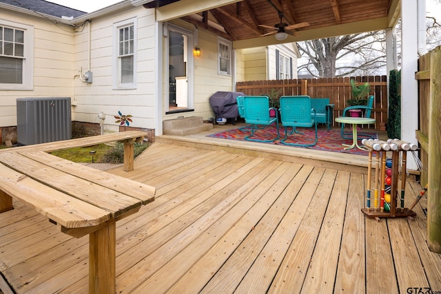 wooden deck featuring a grill, cooling unit, a ceiling fan, and fence