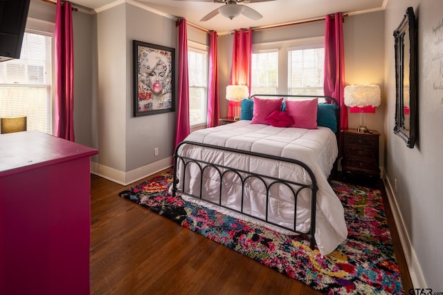 bedroom featuring ceiling fan, baseboards, and wood finished floors