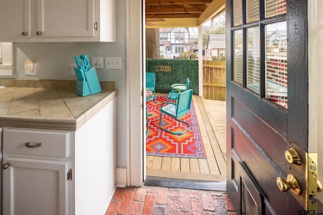 doorway featuring brick floor