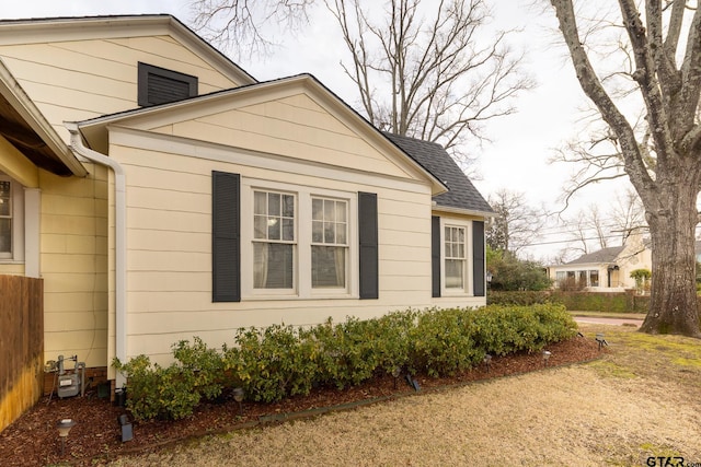 view of home's exterior with a shingled roof