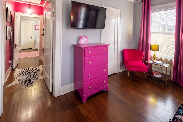 living area with attic access, baseboards, and hardwood / wood-style flooring